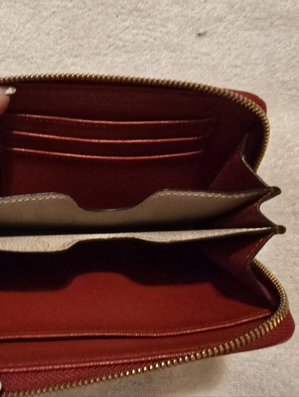 Michael Kors Red ostrich-patterned zip-around wallet featuring 1981 Goldtone